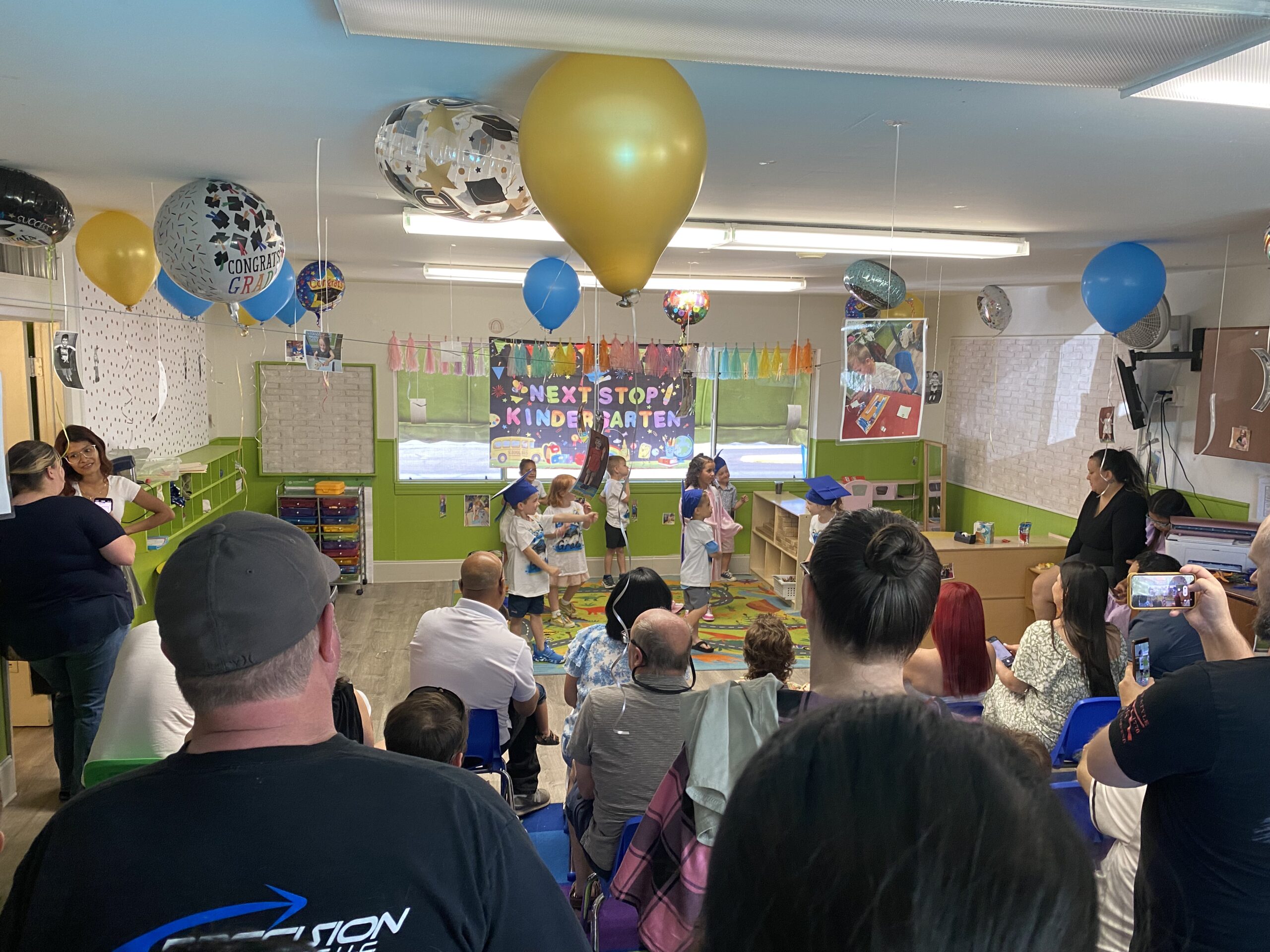 Families and children gathered in a Creative Center classroom