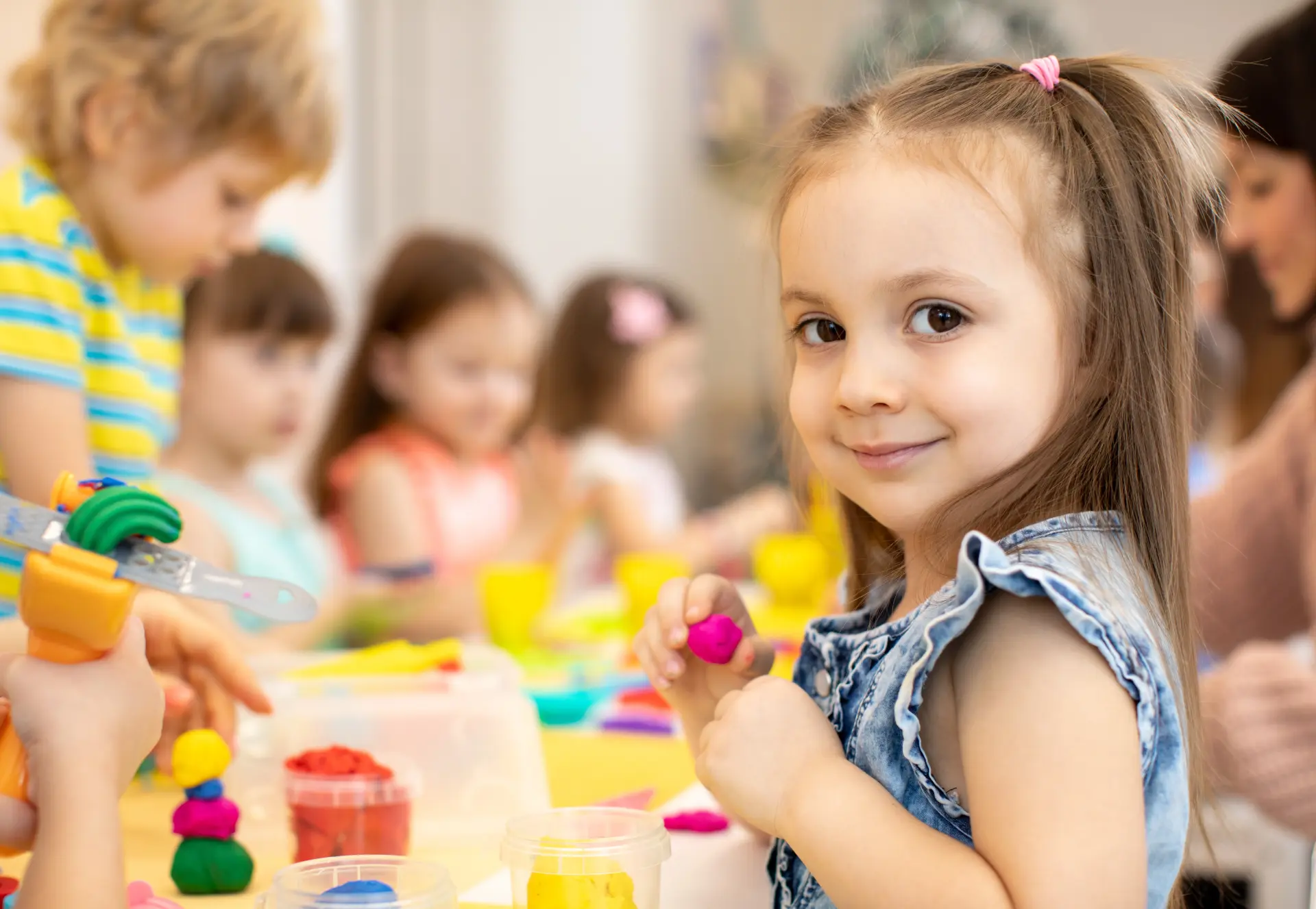 A smiling child enjoying a calm classroom activity