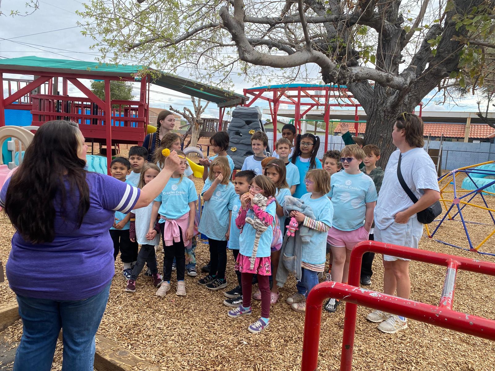 Teachers and children lined up outside for a group activity