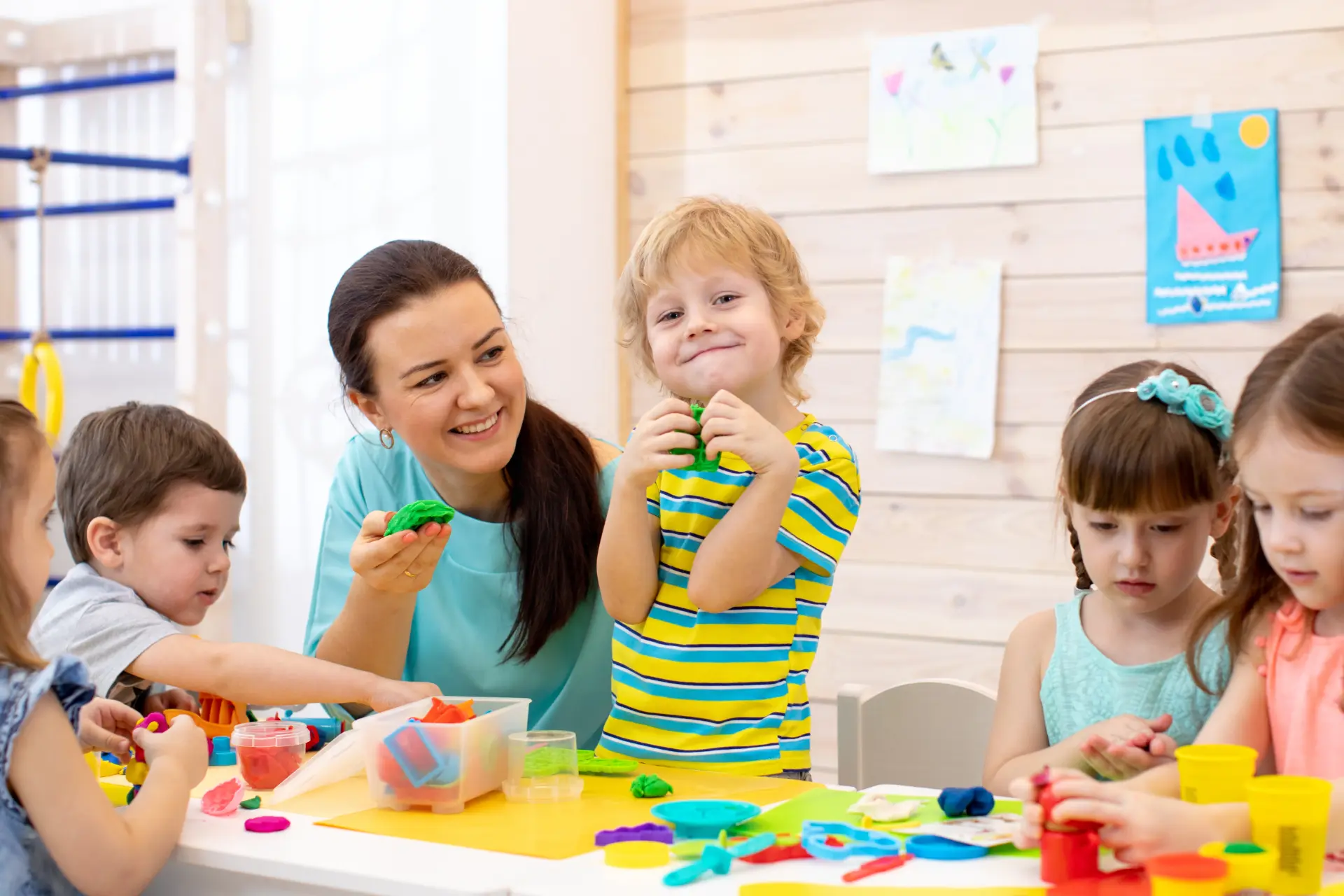 A teacher guiding preschool children through a group activity