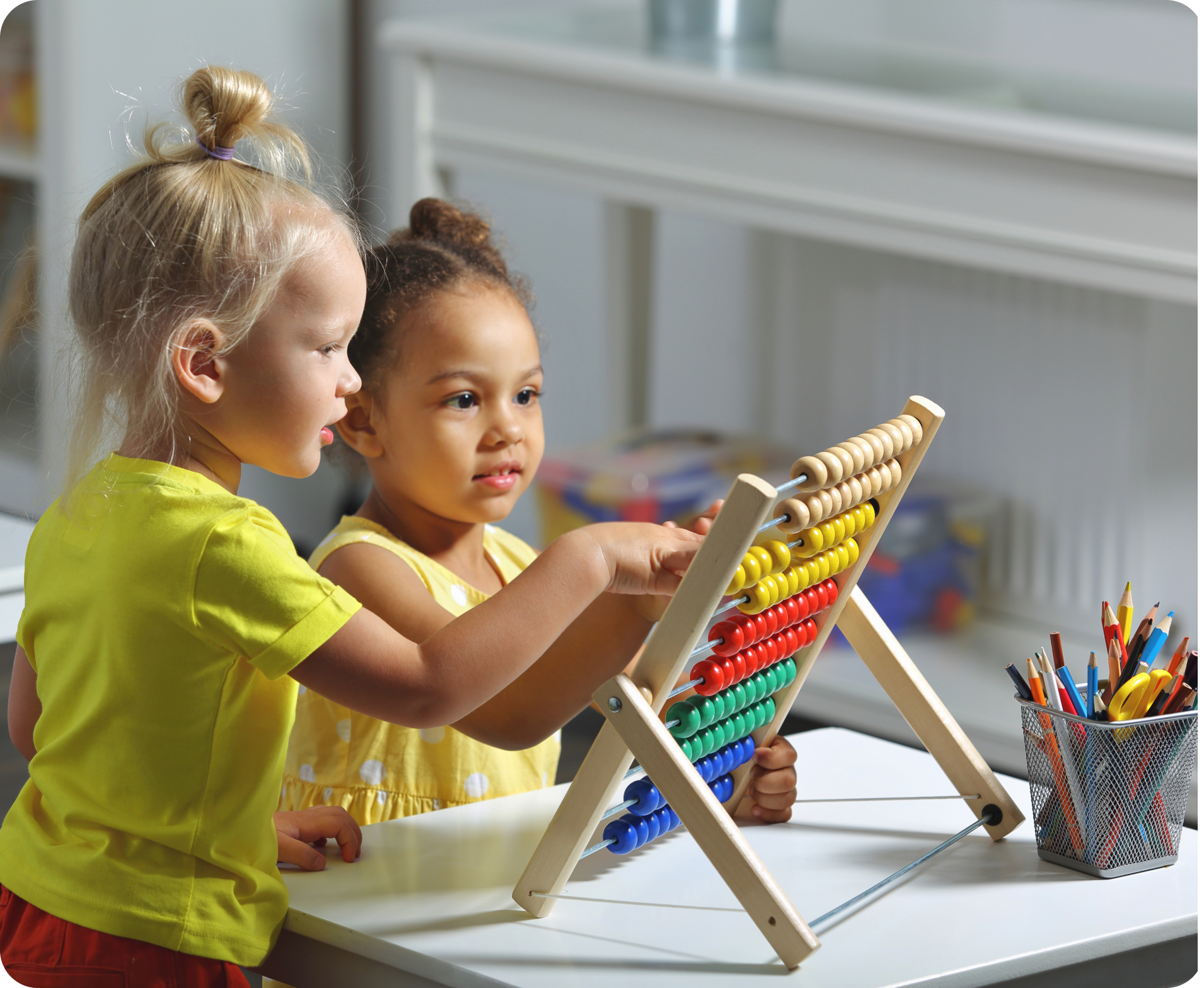 Two girls learning with colorful abacus.